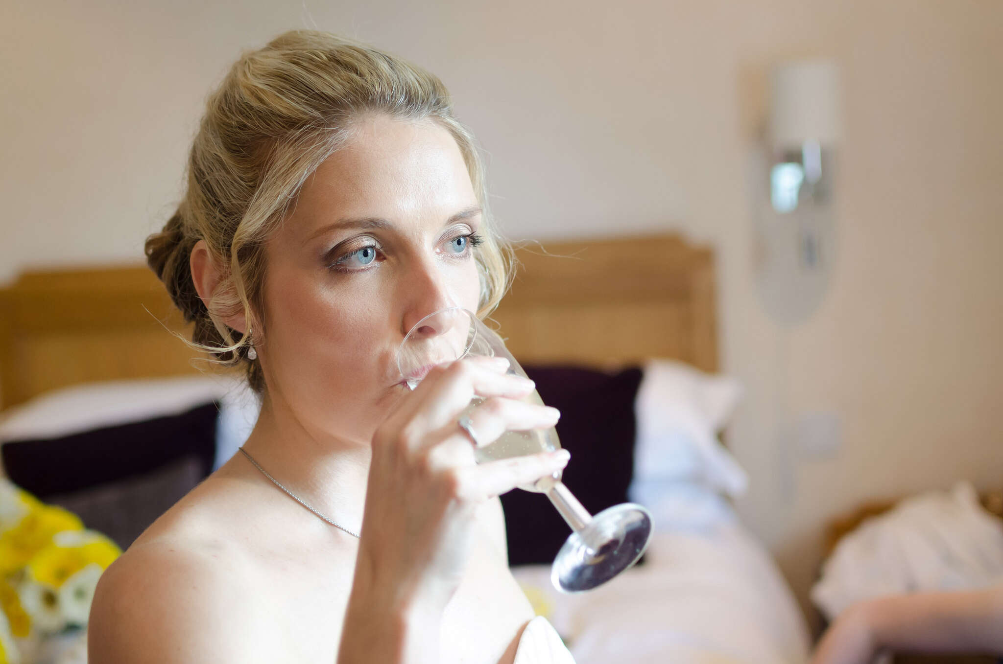 A bride takes a sip of champagne 