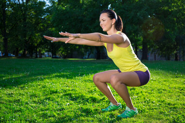 Woman doing squats at park