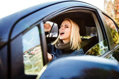 woman singing in car