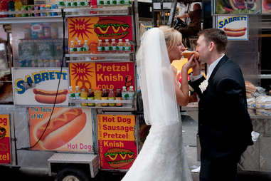 Bride and Groom eat a hot dog