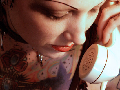 Young woman with thin eyebrows on phone