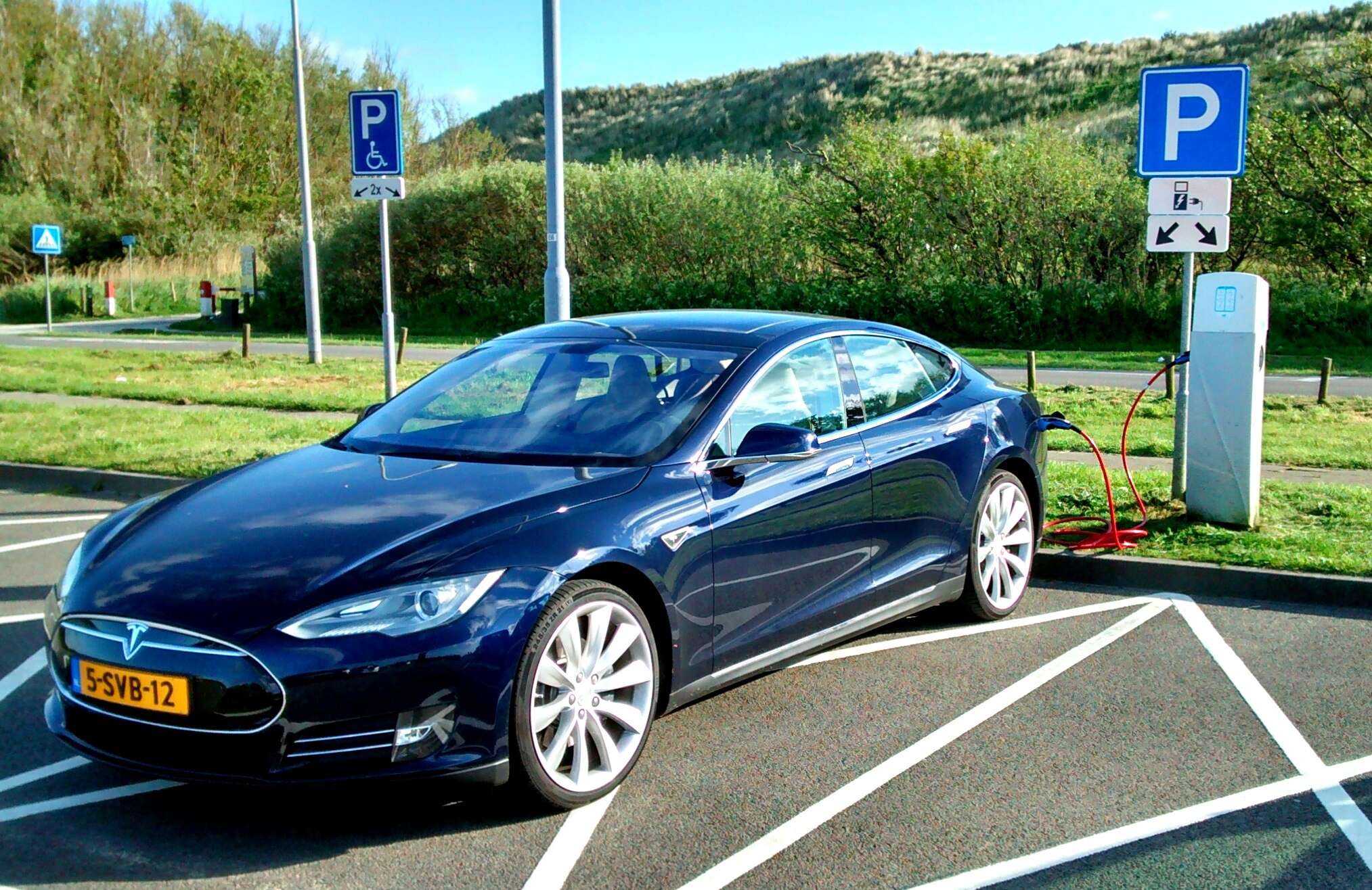 tesla at charging station