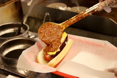 Chili being applied to the half smoke