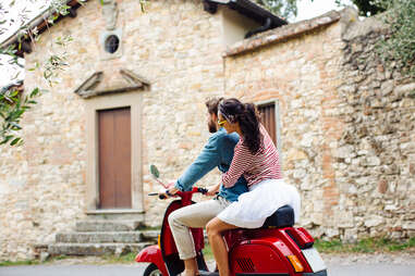 young people riding moped in Florence