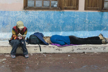 tourist sleeping on the sidewalk 
