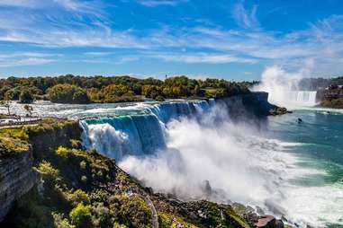 an enormous, powerful waterfall amidst a forest