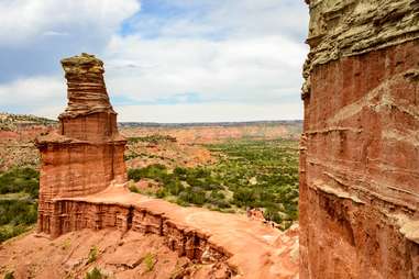 large red rock spires fronted by grassy desert plains