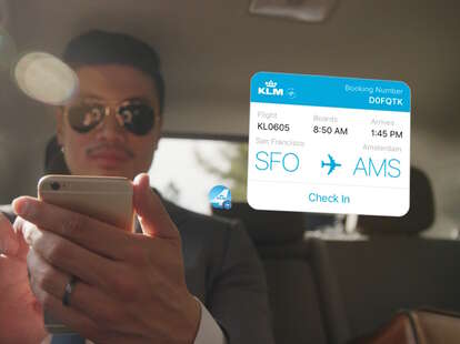 man using facebook messenger in uber