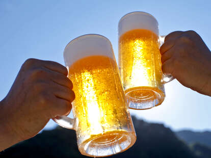 Two people cheers their beers