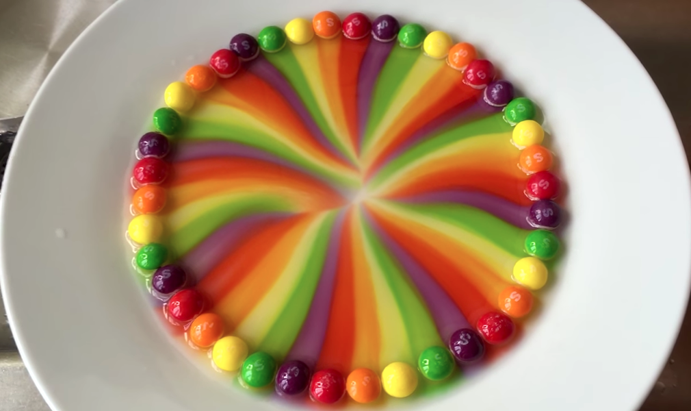 Watch Hot Water Melt Skittles Flavors Rainbow Into Magical Art Thrillist