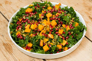 Trader Joe's Thanksgiving kale salad with roasted butternut squash pomegranates seeds starter salads