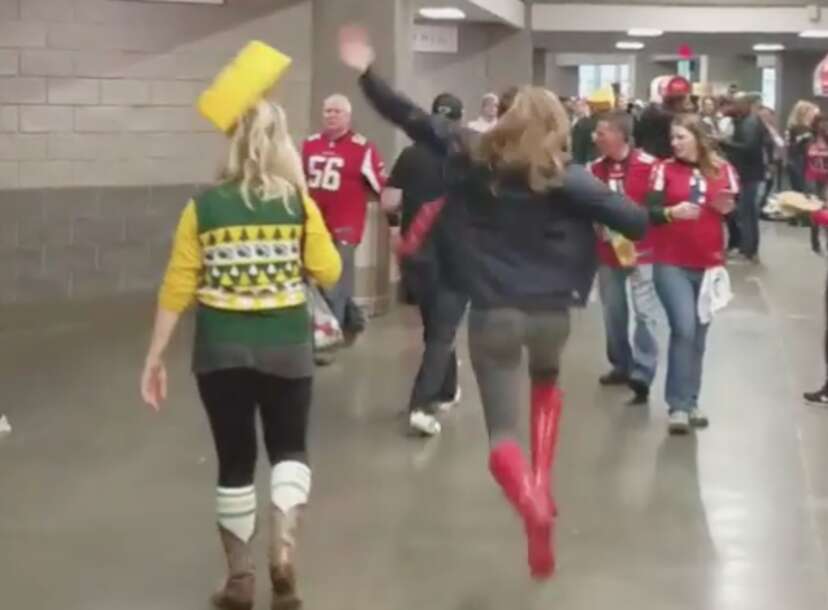 Green Bay Packers fan has cheese sauce poured over his head by