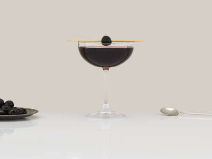 Black Manhattan cocktail in a coupe glass