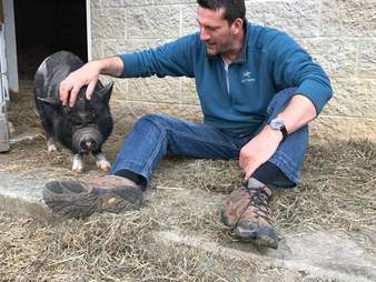 Rescued potbellied pig with her favorite person at Blind Spot Animal Sanctuary