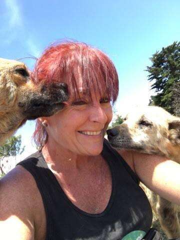 Lya Battle, cofounder of Territorio de Zaguates, a dog sanctuary in Costa Rica, with two of her rescue dogs