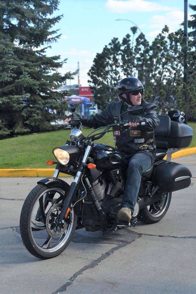 Service dog on back of motorcycle