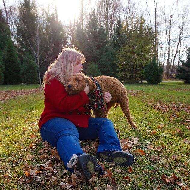 woman hugging her dog outside