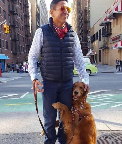 Loubie the golden retriever hugging her owner