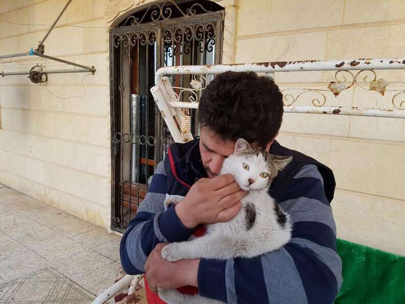 Cat man of Aleppo cuddling a survivor of the war