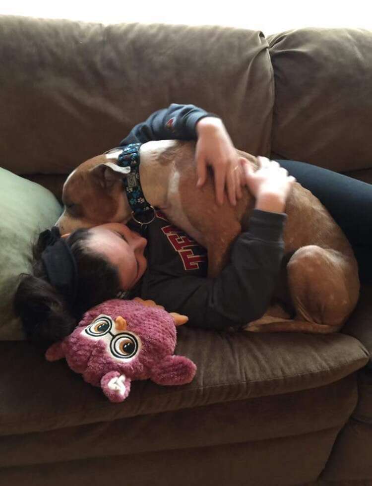 Russ the pit bull hugging his new mom, Kayla