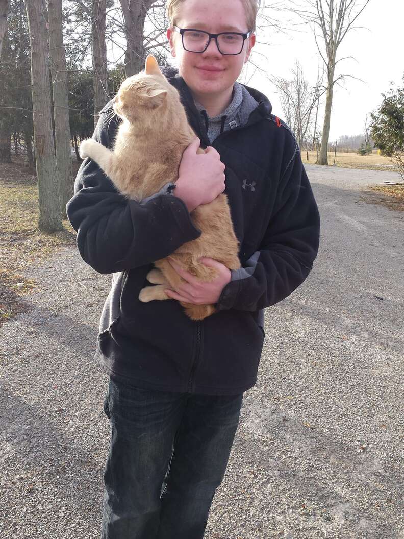 Kid holds cat