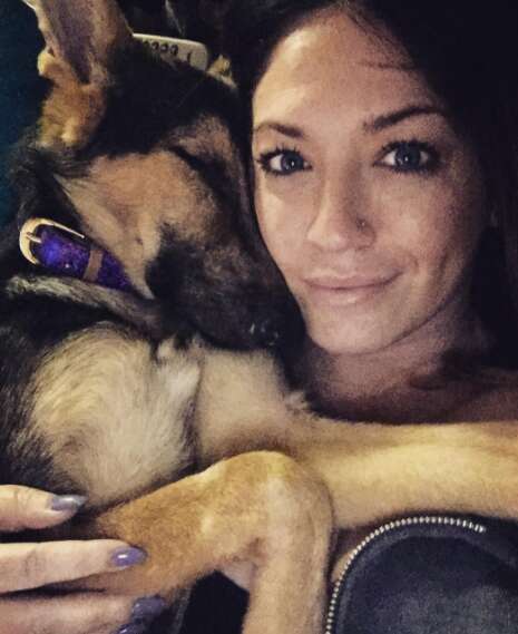 Woman cuddling German shepherd