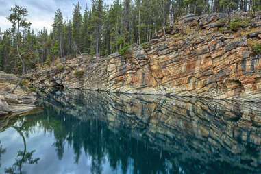 a deep lake near rock cliffs