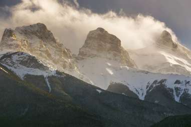 three mountain peaks in clouds