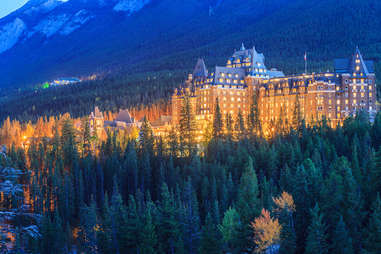 banff springs hotel tucked into a forest at night