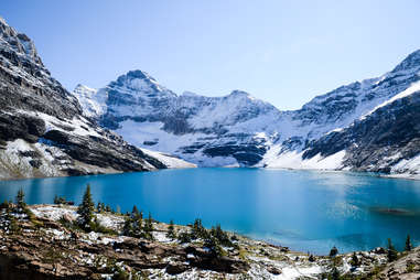 a lake surrounded by enormous mountains