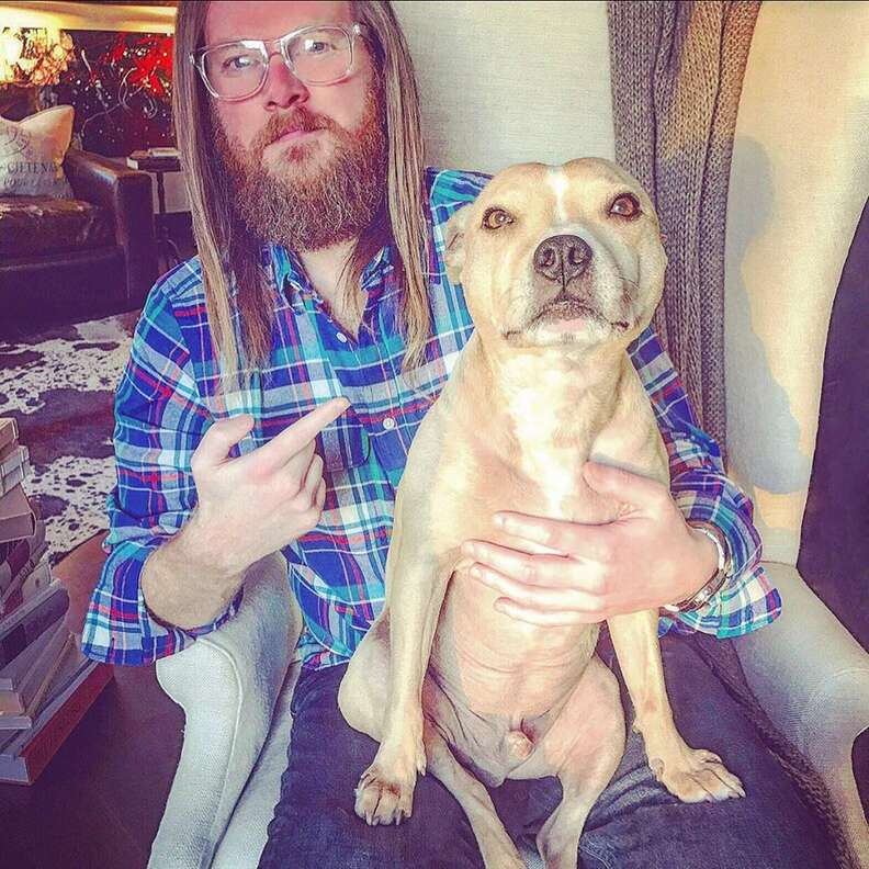 man pointing to his dog