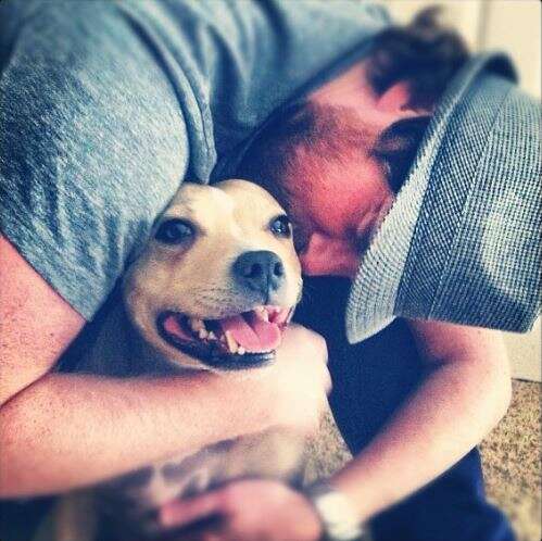 man hugging his dog