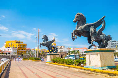horse statues and colorful buildings lining a road