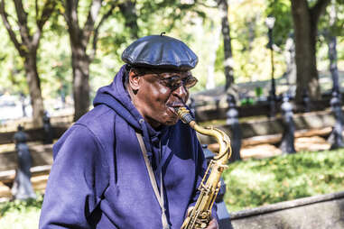 Man playing sax in central park 