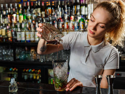 female bartender making a drink