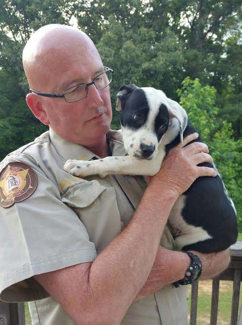Cop cuddling rescue dog