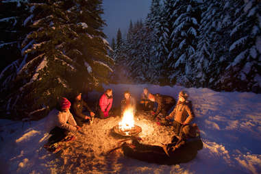 People having a snowshoe bonfire 