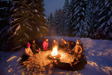 People having a snowshoe bonfire