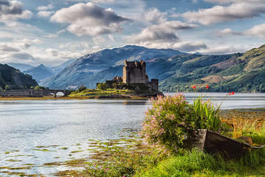 flowers and water in front of the Eilean Donan Castle, Loch Duid, Scotland
