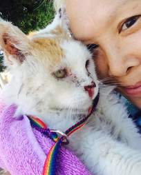 Woman cuddling rescue cat