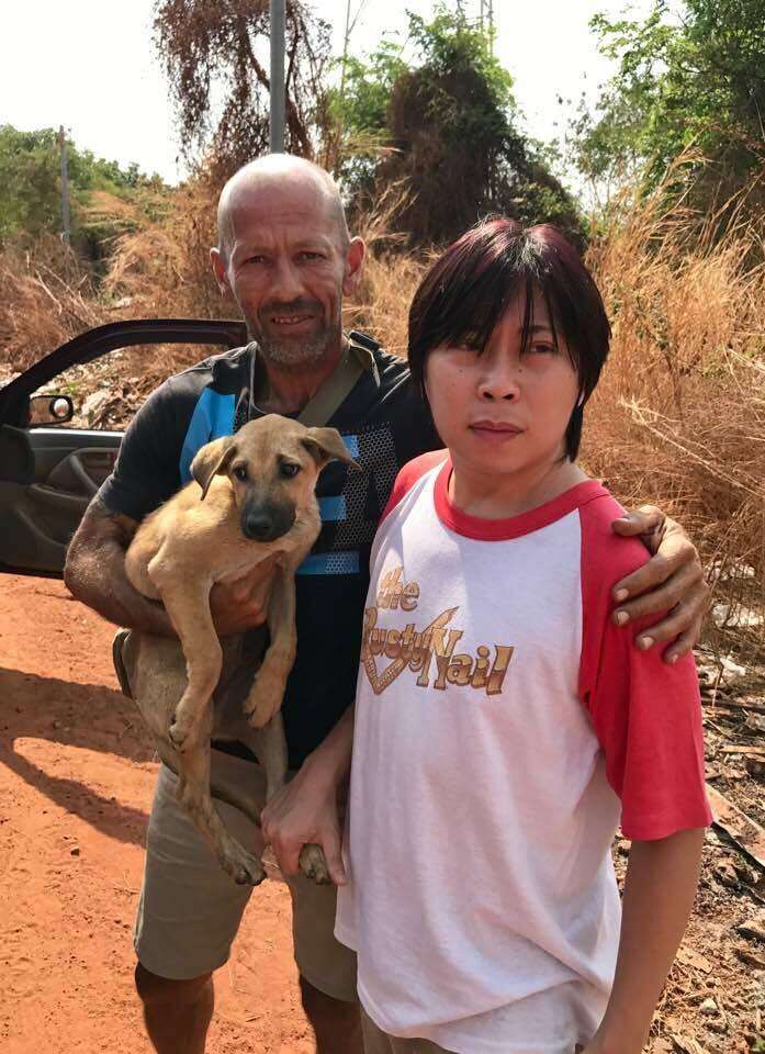 People holding rescued dog