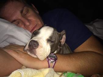 Woman sleeping with puppy