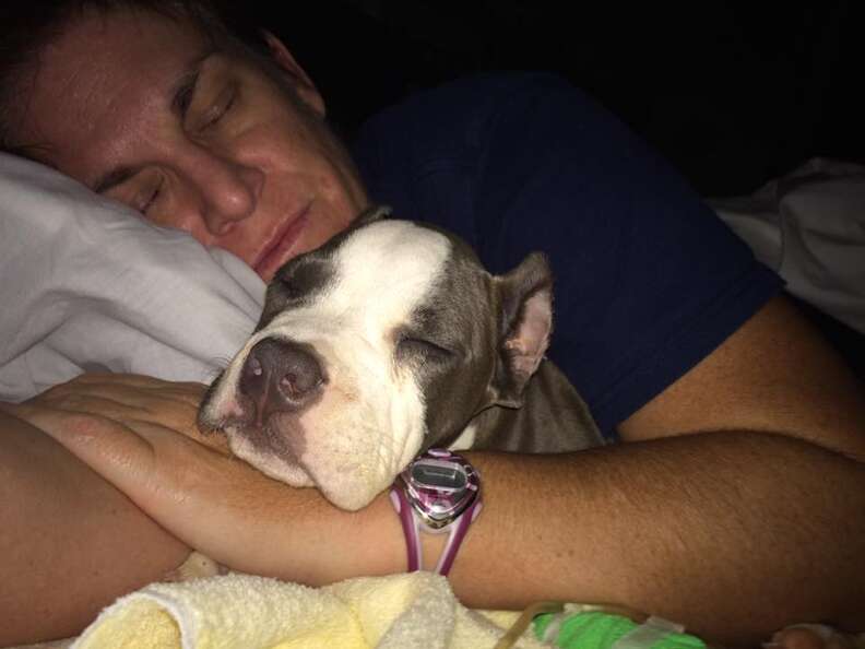Woman sleeping with puppy