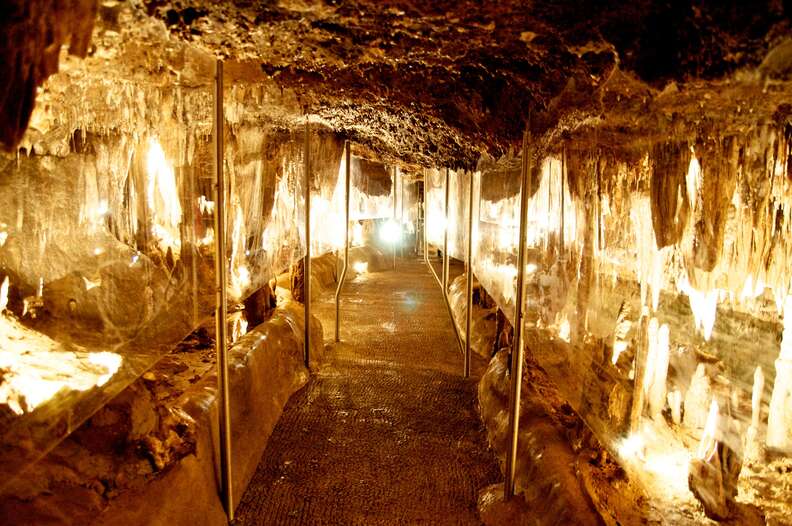 a path leading through a cave with a low ceiling
