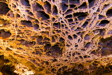 a web-like rock ceiling in a cave
