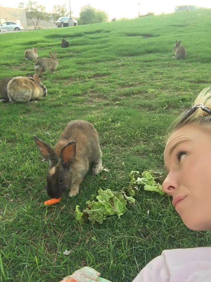 Woman with rabbits at dumping ground