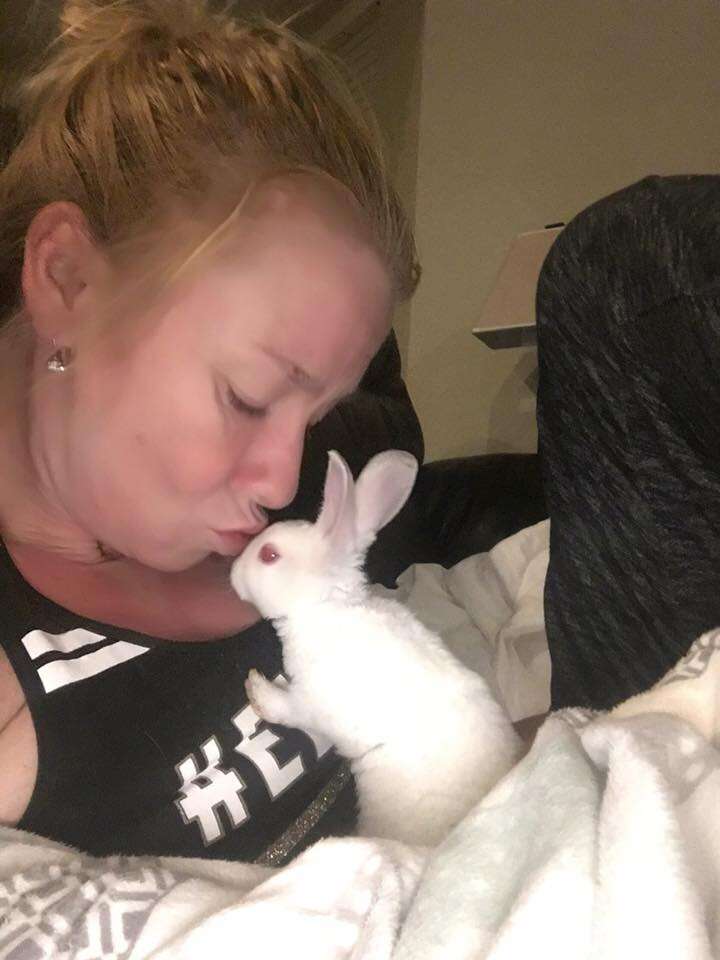 Woman kissing rescued rabbit