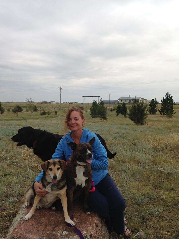 woman holding two dogs