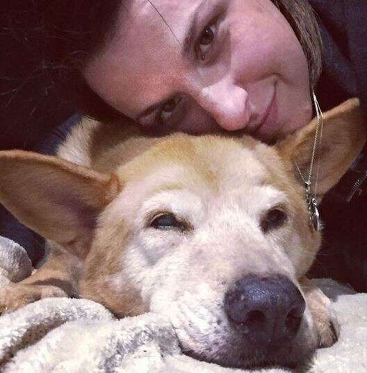 woman laying with dog