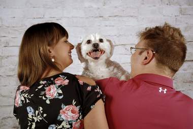 couple does baby photoshoot with dog